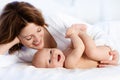 Baby and mother at home in bed. Mom and child. Royalty Free Stock Photo