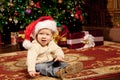 Baby near the Christmas tree. Little boy celebrati