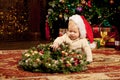 Baby near the Christmas tree. Little boy celebrati