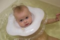 Baby with neck swim ring in bath Royalty Free Stock Photo