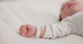 Baby, new born and hand with bracelet on bed for care, trust or support in hospital for birth. Infant, love and hope Royalty Free Stock Photo