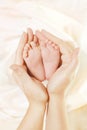 Baby Newborn Feet in Mother Hands. Beautiful New Born Kid Foot, Family Love Concept