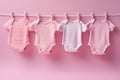 Baby newborn girl pink bodysuits on a line on pink background. Laundry day, baby clothes, baby shower theme, it\'s a girl Royalty Free Stock Photo