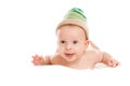 Baby newborn lying on her stomach on the bed in a funny knitted hat isolated on white background, the concept of choosing baby clo Royalty Free Stock Photo