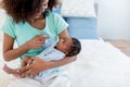 baby newborn son, looking at mother while his mother being held Royalty Free Stock Photo