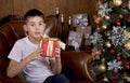 Baby next to the Christmas tree. Christmas Kids. Happy Children Opening Gifts. new year. Boy receiving Christmas gifts Royalty Free Stock Photo