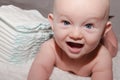 Baby Next to Stack of Disposable Diapers Royalty Free Stock Photo