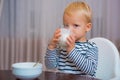 Baby nutrition. Eat healthy. Toddler having snack. Healthy nutrition. Drink milk. Child hold glass of milk. Kid cute boy Royalty Free Stock Photo