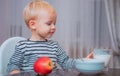 Baby nutrition. Eat healthy. Toddler having snack. Drink milk. Child hold glass of milk. Kid cute boy sit at table with Royalty Free Stock Photo