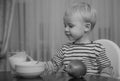 Baby nutrition. Eat healthy. Toddler having snack. Drink milk. Child hold glass of milk. Kid cute boy sit at table with Royalty Free Stock Photo