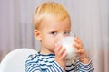 Baby nutrition. Eat healthy. Toddler having snack. Healthy nutrition. Drink milk. Child hold glass of milk. Kid cute boy Royalty Free Stock Photo