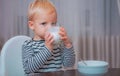 Baby nutrition. Eat healthy. Toddler having snack. Healthy nutrition. Drink milk. Child hold glass of milk. Kid cute boy Royalty Free Stock Photo