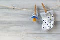 Baby pacifier and socks hanging on clothesline on wooden background Royalty Free Stock Photo