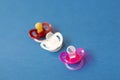 Baby pacifiers are on a blue background