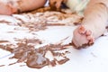 Baby painting with hands with chocolate