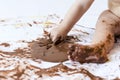 Baby painting with hands with chocolate