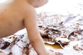 Baby painting with hands with chocolate