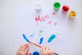 Baby painting picture with fingers or brush for mother