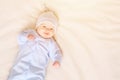 Baby in pajamas lying on bed Royalty Free Stock Photo