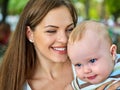 Baby in park outdoor. Kid on mom`s hands. Royalty Free Stock Photo