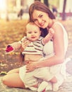 Baby in park outdoor. Kid on mom`s hands. Royalty Free Stock Photo