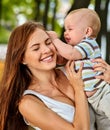 Baby in park outdoor. Kid on mom`s hands. Royalty Free Stock Photo