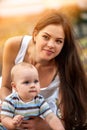 Baby in park outdoor. Kid on mom`s hands. Royalty Free Stock Photo