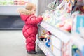 Baby picks a toy at the store