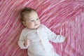 Baby on pink sheet