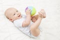 Baby Play Toy Ball, Happy Kid Lying on Back Playing Soft Toys Royalty Free Stock Photo