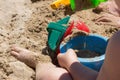 Baby playing with beach bucket and shovel. Royalty Free Stock Photo