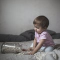 Baby playing on bed of beans, early development, natural toys, Royalty Free Stock Photo