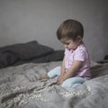 Baby playing on bed of beans, early development, natural toys, Royalty Free Stock Photo