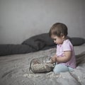 Baby playing on bed of beans, early development, natural toys, Royalty Free Stock Photo