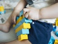 Baby playing with blue and yellow lego bricks Royalty Free Stock Photo