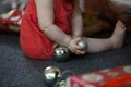 Baby playing with Christmas decorations unidentified and close up