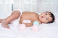 Baby playing color ball on a bed Royalty Free Stock Photo