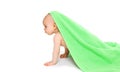 Baby playing crawling under the bright green towel Royalty Free Stock Photo