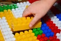 Baby playing and discovery with colorful toys at home, close-up detail. Child plays with plastic building blocks Royalty Free Stock Photo