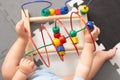 Baby playing with educational toy in nursery. Learning colorful wooden toy.developing toy. The labyrinth of wooden beads Royalty Free Stock Photo