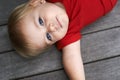 Baby, playing on floor outdoor for development with portrait, curiosity or early childhood in backyard of home. Toddler
