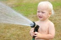 Baby Playing with Garden Hose Royalty Free Stock Photo