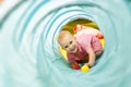 Baby playing inside a toy tunnel Royalty Free Stock Photo