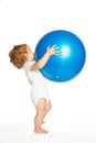 Baby playing with a large fitness ball. Royalty Free Stock Photo