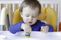 Baby playing with plasticine