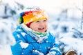 Baby playing with snow in winter. Child in snowy park. Royalty Free Stock Photo