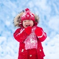 Baby playing with snow in winter. Royalty Free Stock Photo