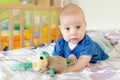 baby playing with soft toy on the bed Royalty Free Stock Photo