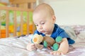 Baby playing with soft toy on the bed Royalty Free Stock Photo