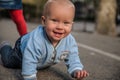 Baby playing on the street and smiling Royalty Free Stock Photo